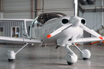 Obraz premium Small private turbo-propeller airplane in hangar