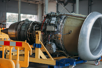 Fototapeta na wymiar Jet airplane turbine on repairing in hangar
