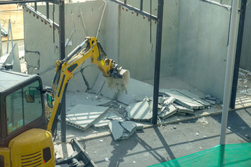excavator backhoe destroy building