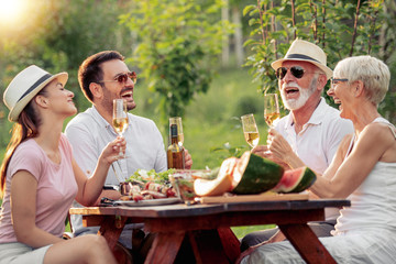 Happy family having picnic in the park on a sunny day