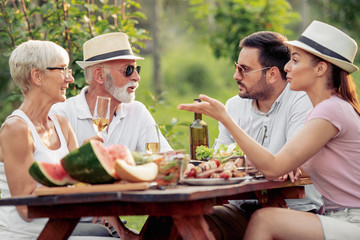 Happy family having picnic in the park on a sunny day