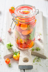 Homemade and tasty canned red tomatoes in the jar