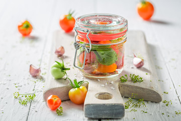 Homemade and tasty pickled red tomatoes in summer