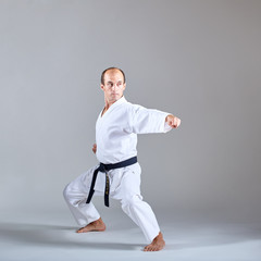 A kick is trained by an athlete in a formal karate exercise © andreyfire