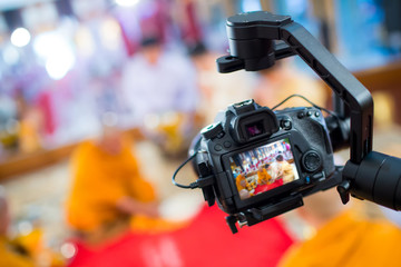 Steadicam with DSLR camera for video production are shooting movie in wedding ceremony. stabilize...