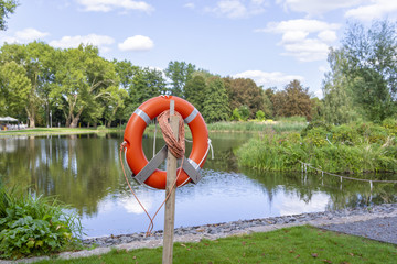 A rescue lifebelt in front of the lake
