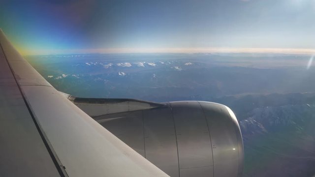 sunny day flying airplane engine passenger window view panorama 4k china
