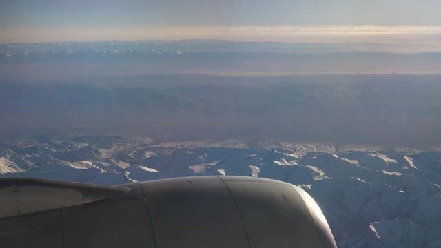 sunny day flying airplane engine passenger window view panorama 4k china

