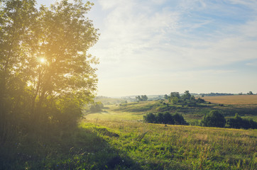 Sunny summer landscape.Beautiful view of green hills,fields and pastures.Nature of Tula region,Russia.