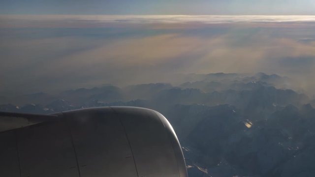 sunny day flying airplane engine passenger window view panorama 4k china