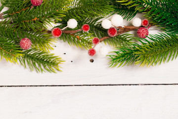 Christmas fir branches with different decorations. Rustic Christmas. Top view flat lay. White old desk.