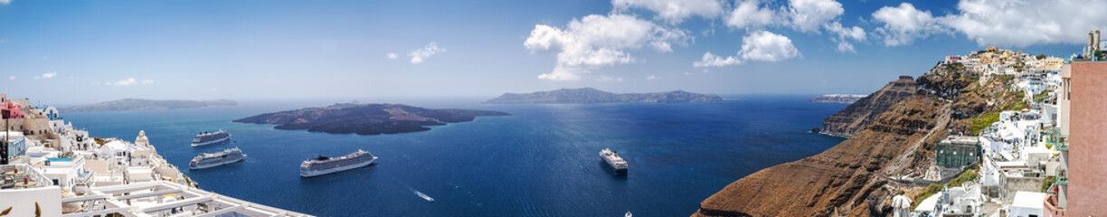 Beautiful panoramic view from touristic Fira town to caldera and volcano and cruise ship at summer...
