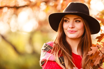 Charming woman walking in autumnal park