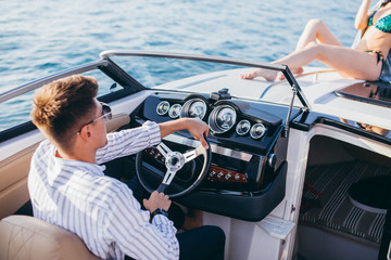 Wealthy succsessful businessman rent a speed luxury motor boat to take a drive with his new...