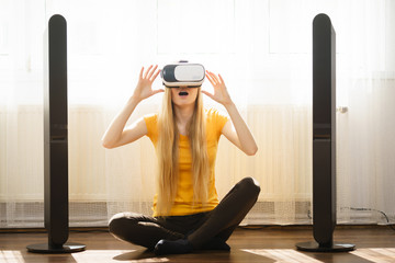 Girl wearing virtual reality goggles at home
