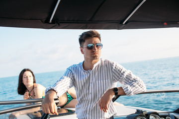 the Young couple navigating on a yacht