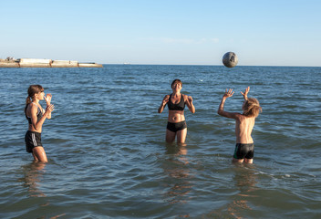 happy family playing in the sea