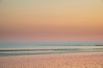 Beautiful vibrant Summer sunset beach landscape with stunning sky and colors