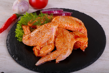 Raw marinated chicken wings