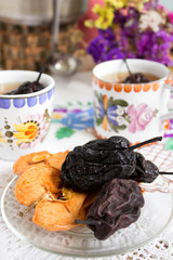 Dried fruits and a healthy compote of dried fruits on a colored background. Rustic style.