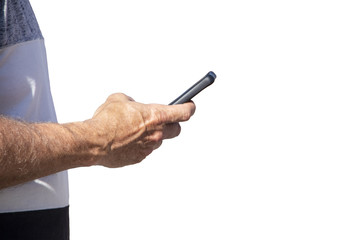 Man stands at edge of frame looking at cell phone isolated on white background with room for copy