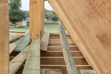 Wood frame residential construction site at sunset, Ukraine.