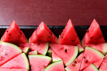 Watermelon slices. Pieces of ripe watermelon in old metal dishes. Red fruit with fructose for a...