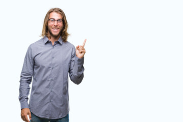 Young handsome business man with long hair over isolated background with a big smile on face, pointing with hand and finger to the side looking at the camera.