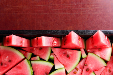 Watermelon slices. Pieces of ripe watermelon in old metal dishes. Red fruit with fructose for a...