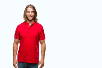 Young handsome man with long hair over isolated background winking looking at the camera with sexy...