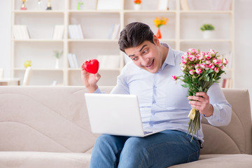 Young man making marriage proposal over internet laptop