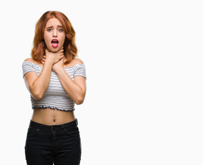 Young beautiful woman over isolated background shouting and suffocate because painful strangle....