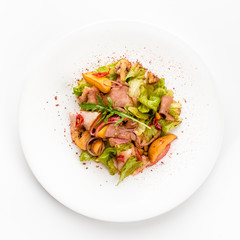Meat salad with roast beef, mushrooms, potatoes, onions, mix of salad, spices, isolated on white background. Top view