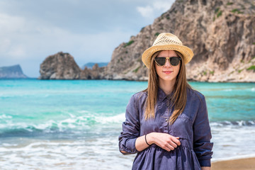 Fototapeta premium Summer lifestyle portrait of pretty young woman on the beach.