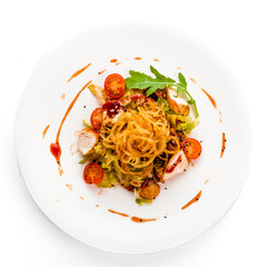 Chicken salad with tomatoes, arugula and French onions white plate. Top View