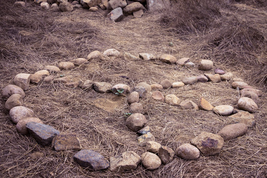 sign of peace laid out of stones on ground