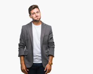 Young handsome business man over isolated background puffing cheeks with funny face. Mouth inflated with air, crazy expression.