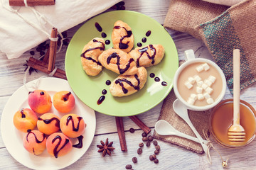 Breakfast of coffee, croissants, apricots, honey, cinnamon and anise