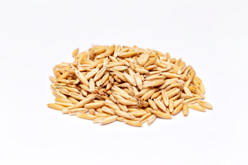 Macro pile of unpeeled raw oat isolated at white background.