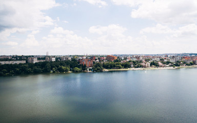 Fototapeta na wymiar Aerial view of the green picturesque town on the shore of the lake. Ternopil. Ukraine. The concept of a healthy lifestyle