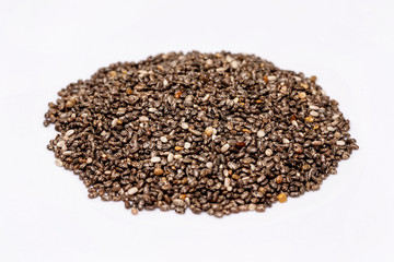 Macro image of chia superfood seeds pile isolated at white background.