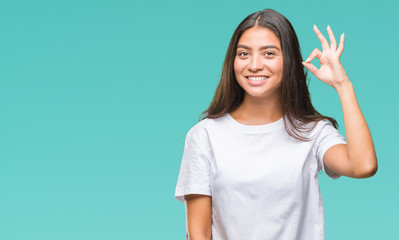 Young beautiful arab woman over isolated background smiling positive doing ok sign with hand and...