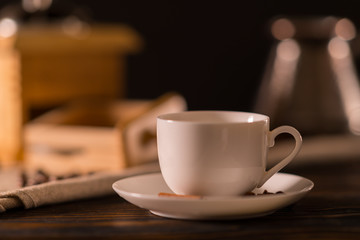 Plain white coffee cup on a wooden kitchen table