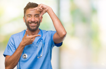 Adult hispanic doctor or surgeon man over isolated background smiling making frame with hands and fingers with happy face. Creativity and photography concept.