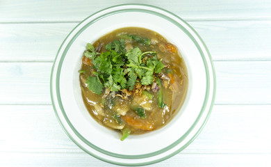 Thai food Fried noodle with seafood isolated in a white plate on wooden table,Top view,Copy space.