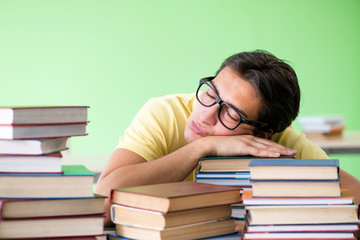 Student with too many books to read before exam