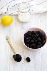 Fototapeta na wymiar Ingredients for blackberry jam on white wooden table, high angle view.
