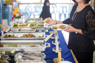 Food Buffet Catering Dining Eating Party Sharing Concept.people group catering buffet food indoor in luxury restaurant with meat colorful fruits and vegetables