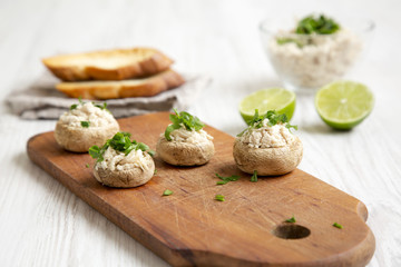 Mushroom and chicken puree with lime and toasts over white wooden surface, side view. Closeup. Selective focus.