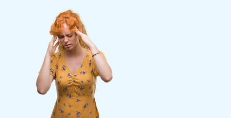 Young redhead woman with hand on head for pain in head because stress. Suffering migraine.